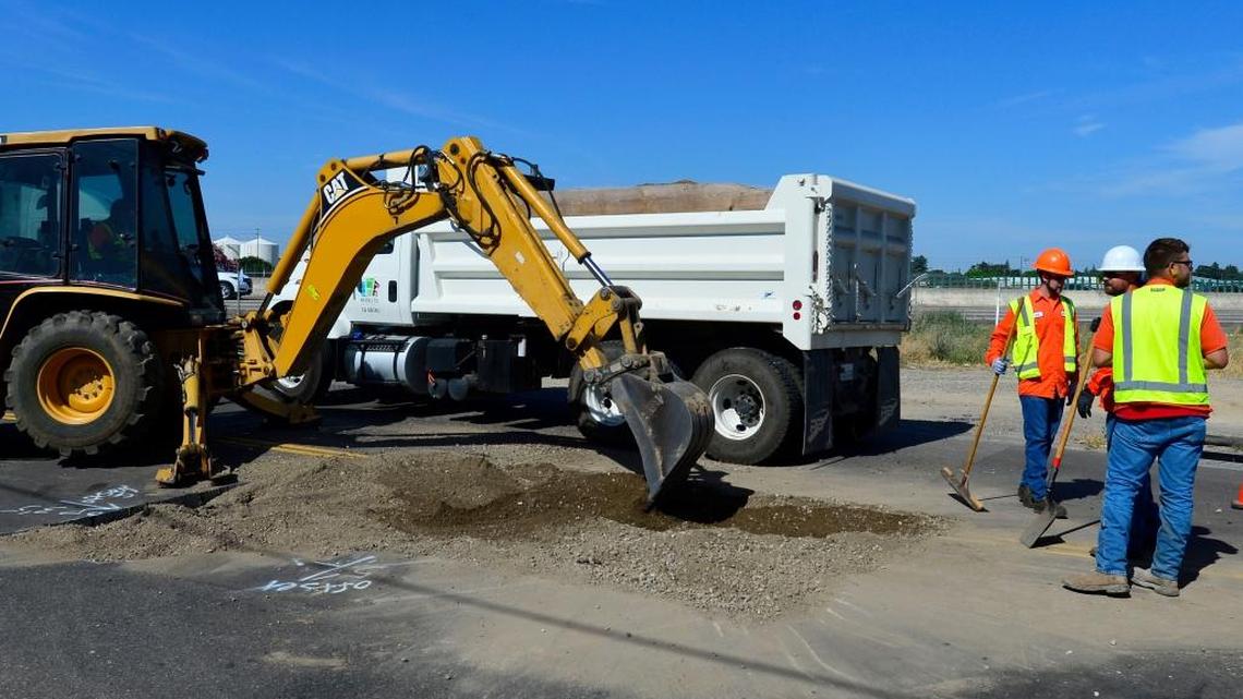 Modesto City Workers fill in a sink hole on Emerald ave just north of Kansas in Modesto California on June 3, 2016.