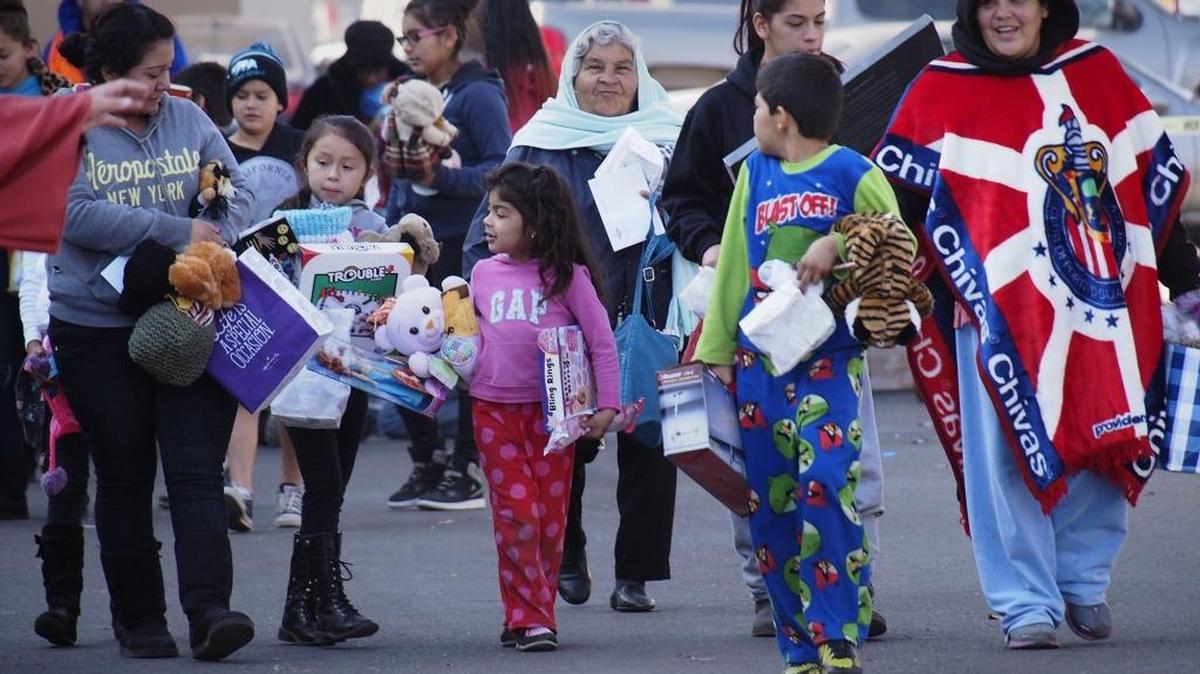 Some of the recipients after leaving the 2014 Happy Birthday Jesus Party at the Modesto Gospel Mission.