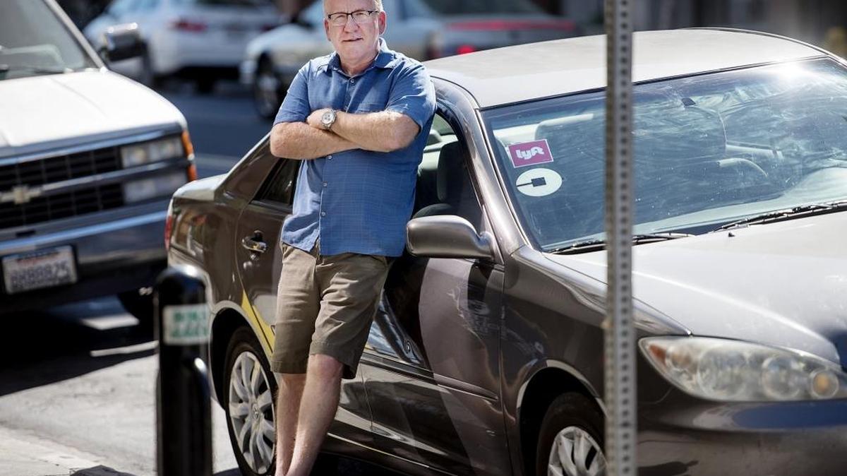 Steve La Farge of Ceres, a longtime pastor who was diagnosed with Parkinson’s disease seven years ago, on Wednesday stands by the car that is now his primary source of income. The diseases has “settled” in his voice, he said, making it impossible for him to preach. So he began driving for Uber and Lyft, and blogging about it.