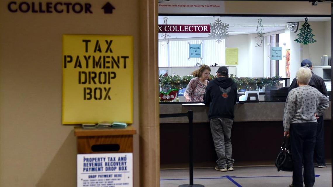 People are pictured Thursday December 28th, 2017 at the Stanislaus County tax collector's office at Tenth Street Place in downtown Modesto, Calif.