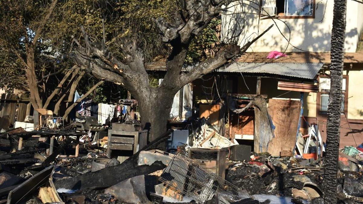 About a dozen people were displaced by a fire that destroyed a travel trailer and damaged two homes at Madera Avenue and Center Street just south of downtown Modesto early Tuesday.