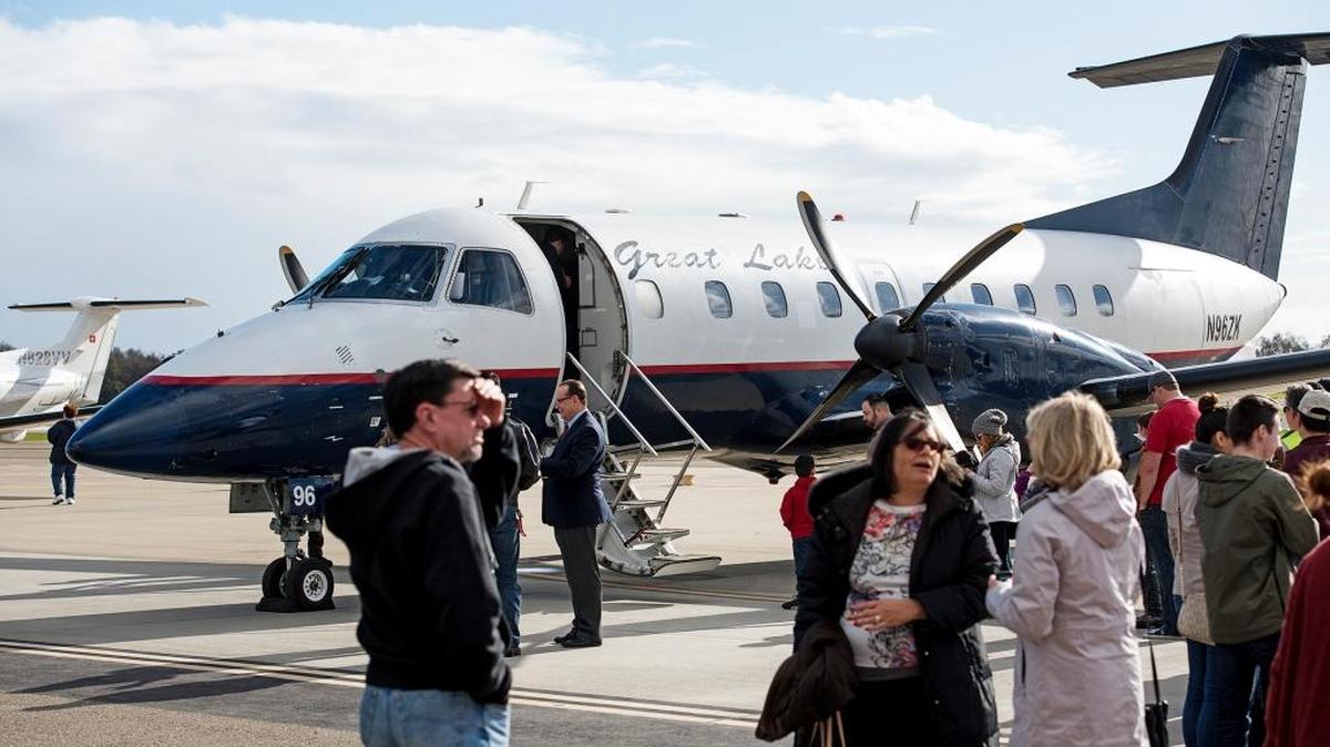 Guests wait in line for a look at the Great Lakes 30-seat EMB-120 Brasilia at the Modesto Airport on Thursday.