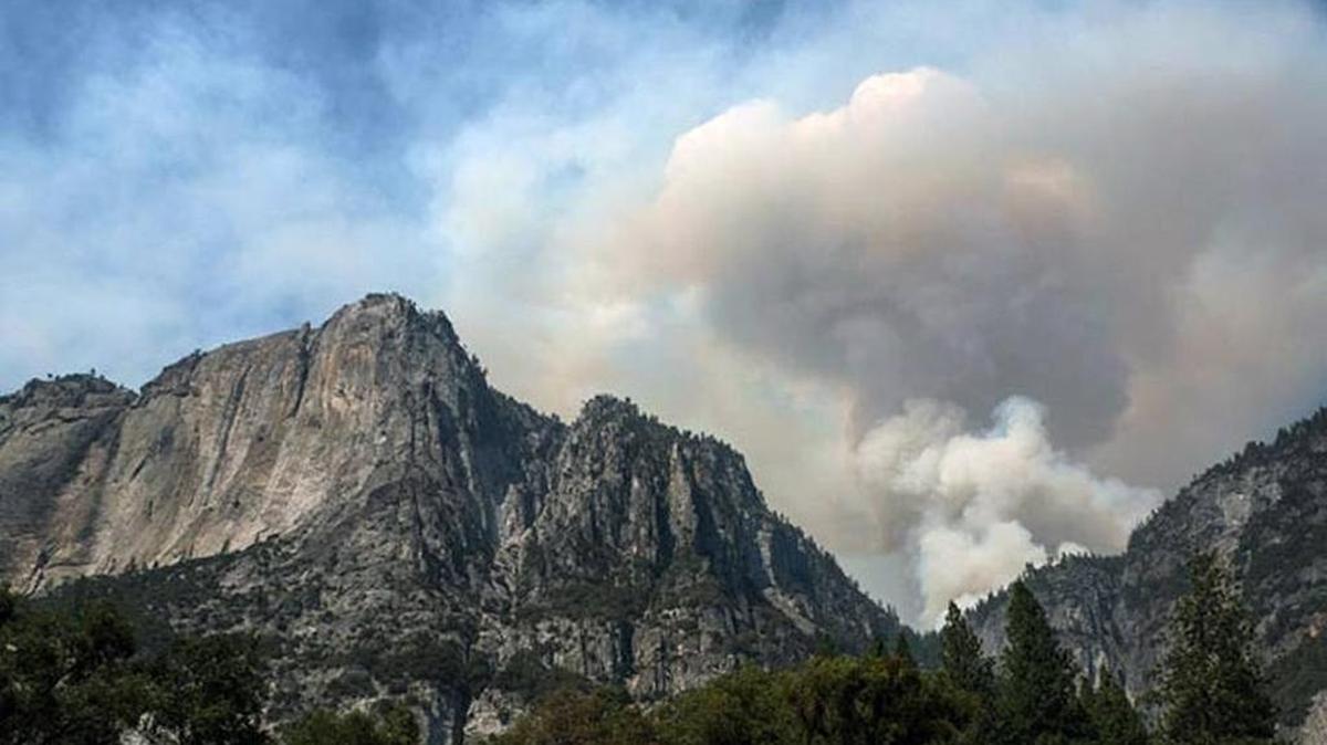
Smoke billows from a fire in Indian Canyon above the north rim of Yosemite Valley on Tuesday.
