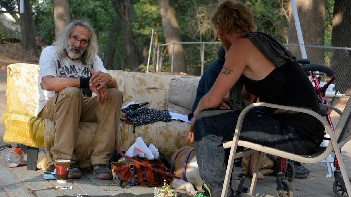 
Mark O’Neill, 63, sits in his illegal campsite in Moose Park in Modesto on Thursday.

