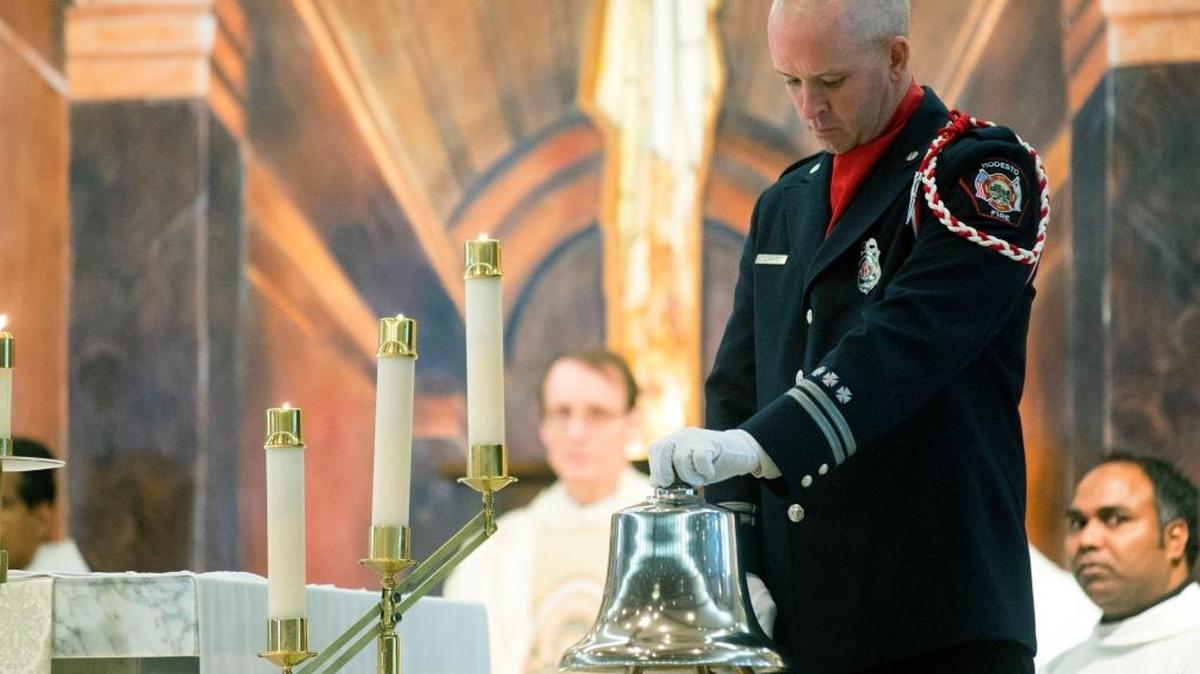 Jason Fritz rings the last alarm bell in honor of fallen firefighters during the annual Blue Mass for first responders in Stanislaus County at St. Joseph’s Church in Modesto on Jan. 9, 2016.
