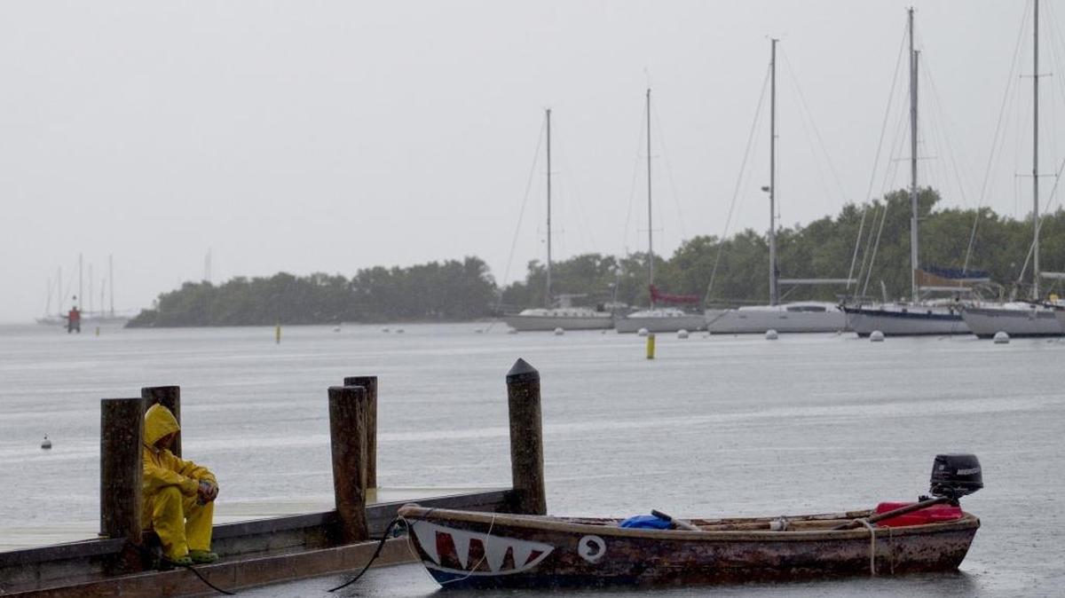 A man sits on a pier at the Dinner Key boat ramp on Thursday, October 6, 2016 in Coconut Grove, as the weather starts to get bad from the arrival of the outer bands of Hurricane Matthew.