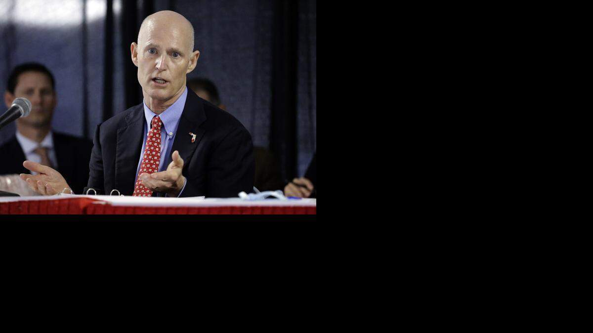 
Florida Gov. Rick Scott gestures last month during a Cabinet meeting at the Florida State Fair.
