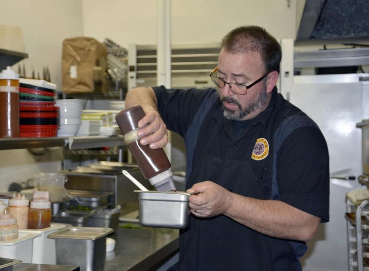 Modesto chef and restaurateur Tye Bauer cooks inside his restaurant Bauer’s 66 1/2 Skillet & Grill in the McHenry Village.
