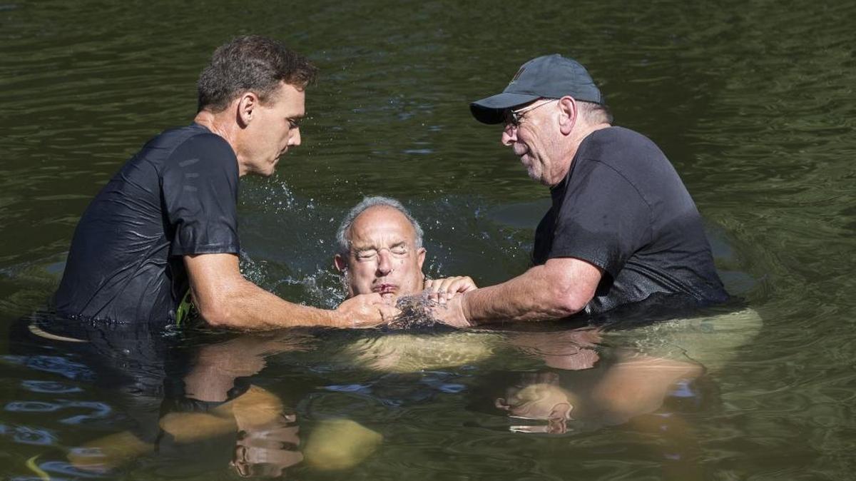 Bruce Brooks is baptized by Pastor David Tomatis, right, and Pastor Kevin Oliver, left, during Sundays event. Well Community Fellowship of Modesto baptized just under 30 newcomers Sunday Aug. 27th 2017 in the Stanislaus River at the McHenry Recreation Area. After a few up spirited songs sung by about 150 church goers they worked their way down a path to the river and one by one were baptized by Pastor David Tomatis and Pastor Kevin Oliver.