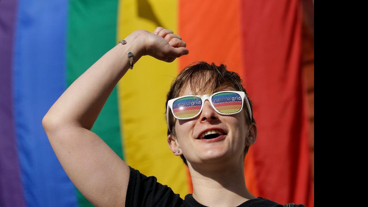 
Jessica Chesnutt, visiting from Brooklyn with her wife for Pride weekend, cheers outside of City Hall in San Francisco on Friday after a ruling by the U.S. Supreme Court that same-sex couples have the right to marry nationwide.

