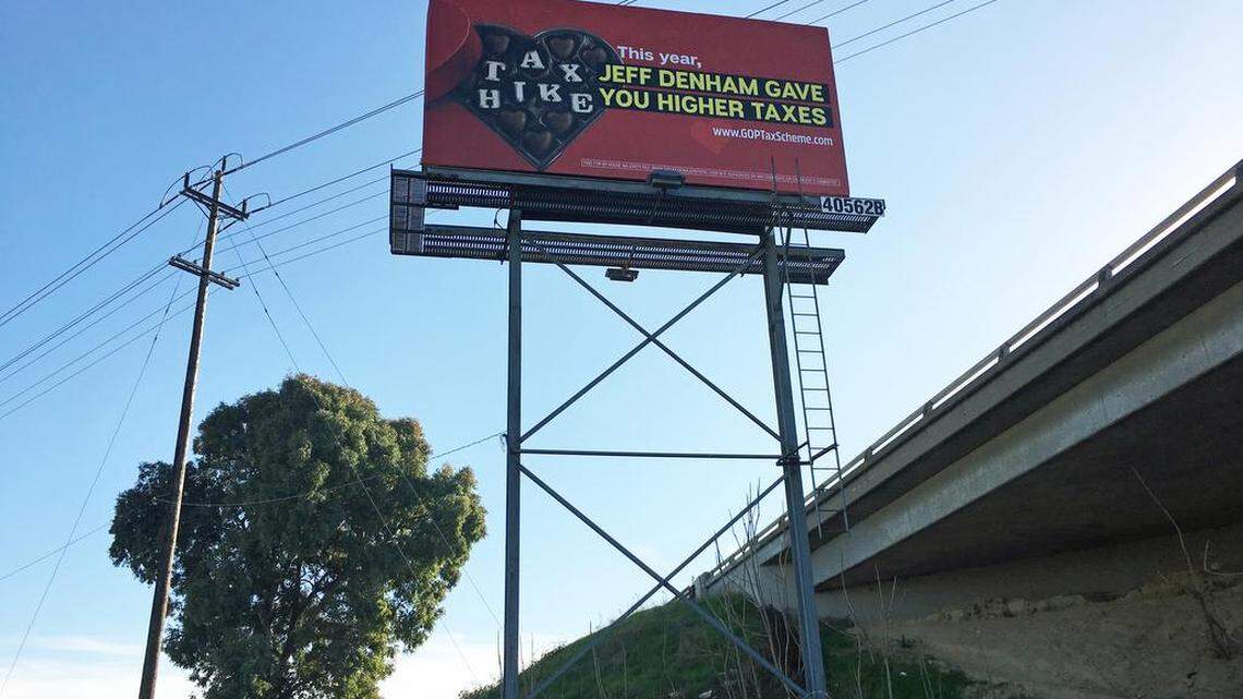 Democrats put up a sign attacking Congressman Jeff Denham's vote on the tax bill. The sign greets drivers on southbound Highway 99 as they pass over Ninth Street in Modesto, California.