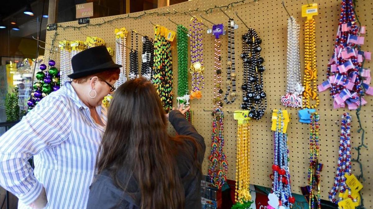Sharon Davis, left, and Suzie Smith organize an assortment of beads during the Mardi Gras celebration in downtown Modesto on Saturday, Feb. 6, 2016.