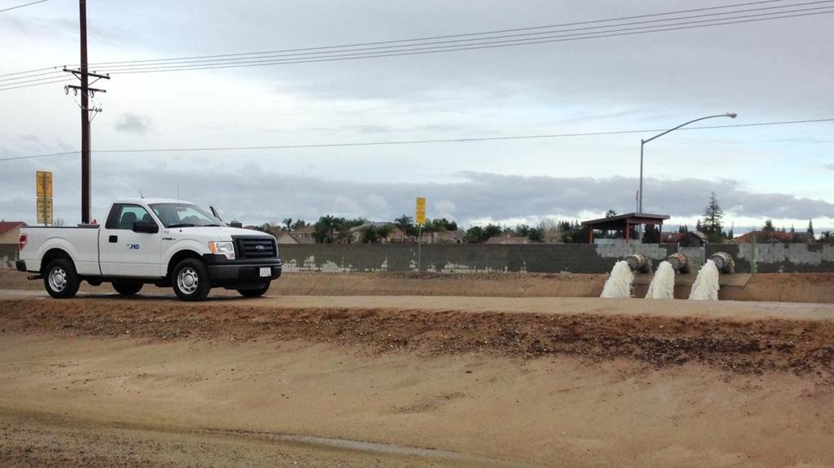 A Modesto city pump puts storm water from Village I into a canal owned by the Modesto Irrigation District, in December 2014.