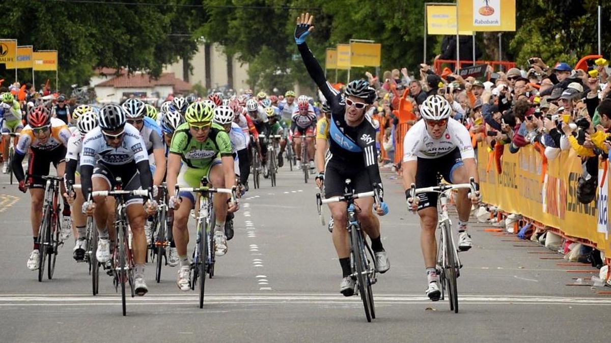 The winner of the Amgen Tour of California, stage 3 finish in Modesto on May 17, 2011, with hand raised, is Greg Henderson from Team Sky. Thor Hushovd from Team Garmin-Cervelo, at right, took third place. Rider in the white Saxo Bank Sungard jersey is Juan Jose Haedo, second place finisher.