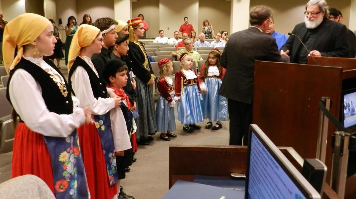 
Representatives of the Greek Orthodox Church of the Annunciation appear before the Modesto City Council on Tuesday  evening. At right, Father Jon Magoulias shakes hands with Mayor Garrad Marsh.
