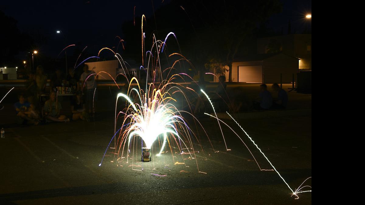 
People watch a fireworks show with safe-and-sane fireworks in The Modesto Bee parking lot on Monday evening in downtown Modesto. Fireworks increase levels of dangerous particulate matter and pose a health threat to those watching them and surrounding neighbors, according to the San Joaquin Valley Air Pollution Control District.
