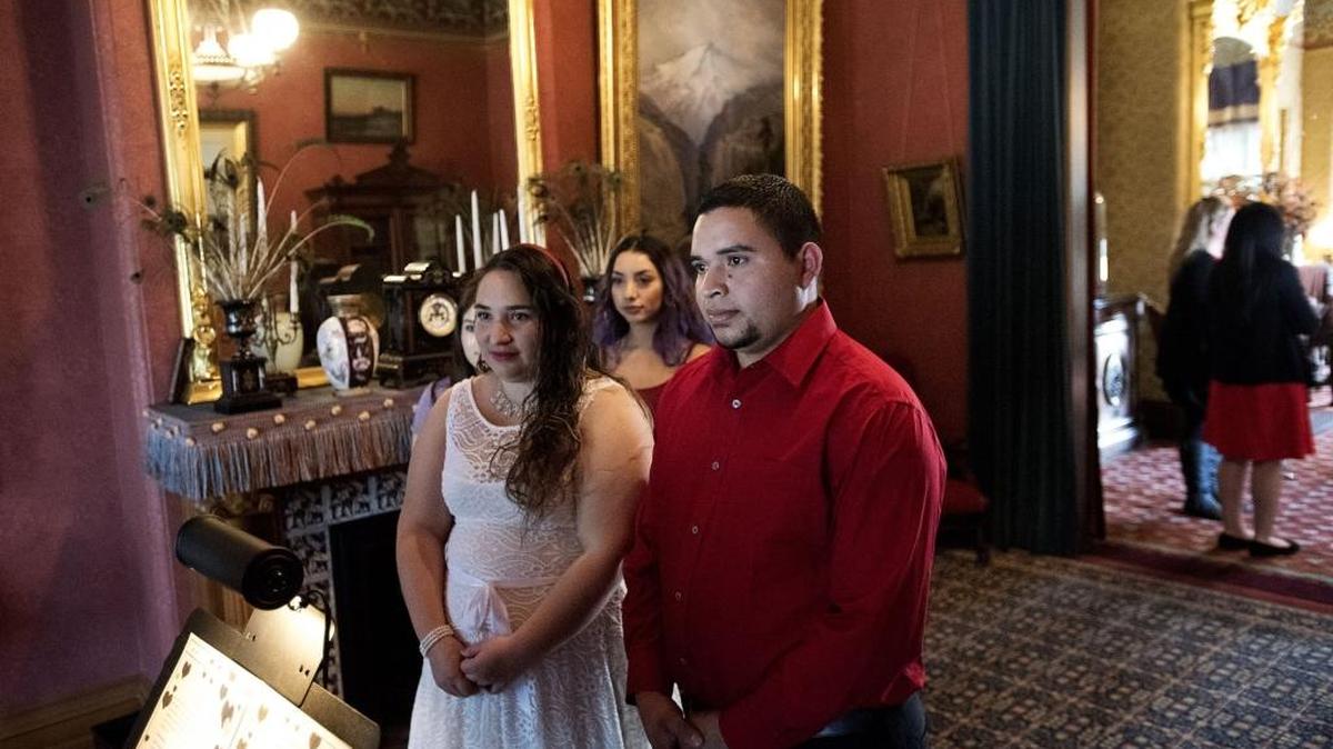 Modesto residents Laura and Adelso Escobar exchange wedding vows Tuesday during the “Marriage at the Mansion” event at the McHenry Mansion in Modesto.