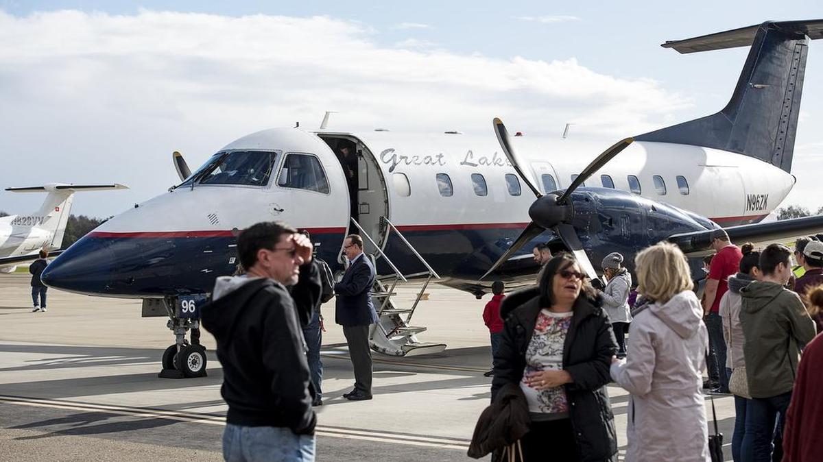 Guests wait in line for a look at the Great Lakes Airlines 30-seat EMB-120 Brasilia at the Modesto Airport on Jan. 19, 2017. The airline has suspended its plan to bring flights to the city.