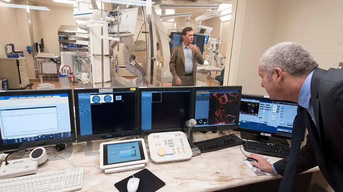 Dr. James Jaffe, middle, demonstrates the new bi-plane fluoroscopy surgical unit at Doctors Medical Center in Modesto, Calif., on Thursday, April 20, 2017.