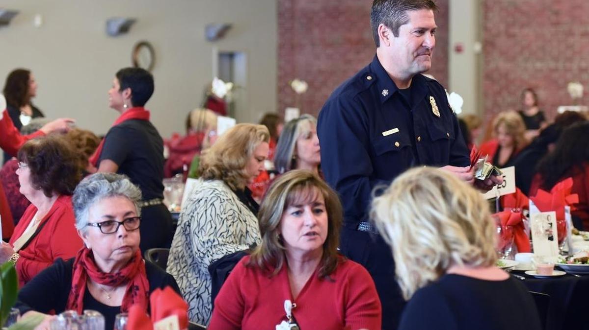 Modesto fire Chief Sean Slamon sells raffle tickets Friday afternoon, Feb. 5, 2016, at the Women Wear Red for Heart Awareness event at the Martin G. Peterson Event Center in downtown Modesto.