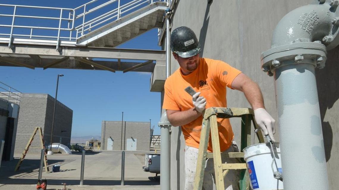 
Sean Kelly with River City Painting works on finishing touches at the Jennings Waste Water Treatment plant southwest of Modesto, Calif. on Thursday morning (09-17-15) The City of Modesto utilities department dedicated the Phase 2 BNR / Tertiary Wastewater Treatment Facility today.
