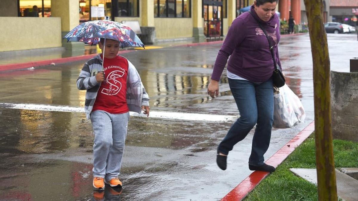 Alex Rangel, 6, and his mother, Mayola, make their way to their car with their groceries Friday afternoon, March 4, 2016, in the parking lot of Save Mart on Prescott Road and Standiford Avenue in Modesto.