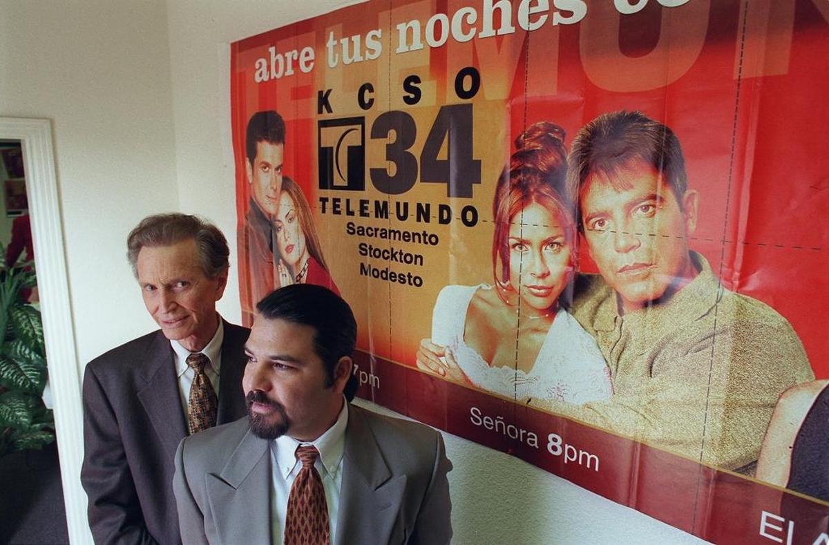 In December 1999, Chester Smith, owner of Telemundo Channel 34 in Modesto, is shown in the lobby of the station office and studio with station manager Rob Castro.