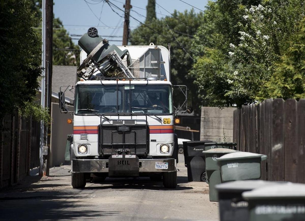 Bertolotti Disposal collects garbage and green waste in an alley behind Princeton Avenue in Modesto, Calif., on Thursday, June 30, 2016.