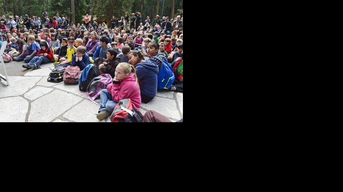 
Schoolchildren and visitors gather at the Yosemite Falls viewing area begins the Yosemite National Park’s 125th Anniversary Kickoff ceremony Tuesday, March 24, 2015. 
