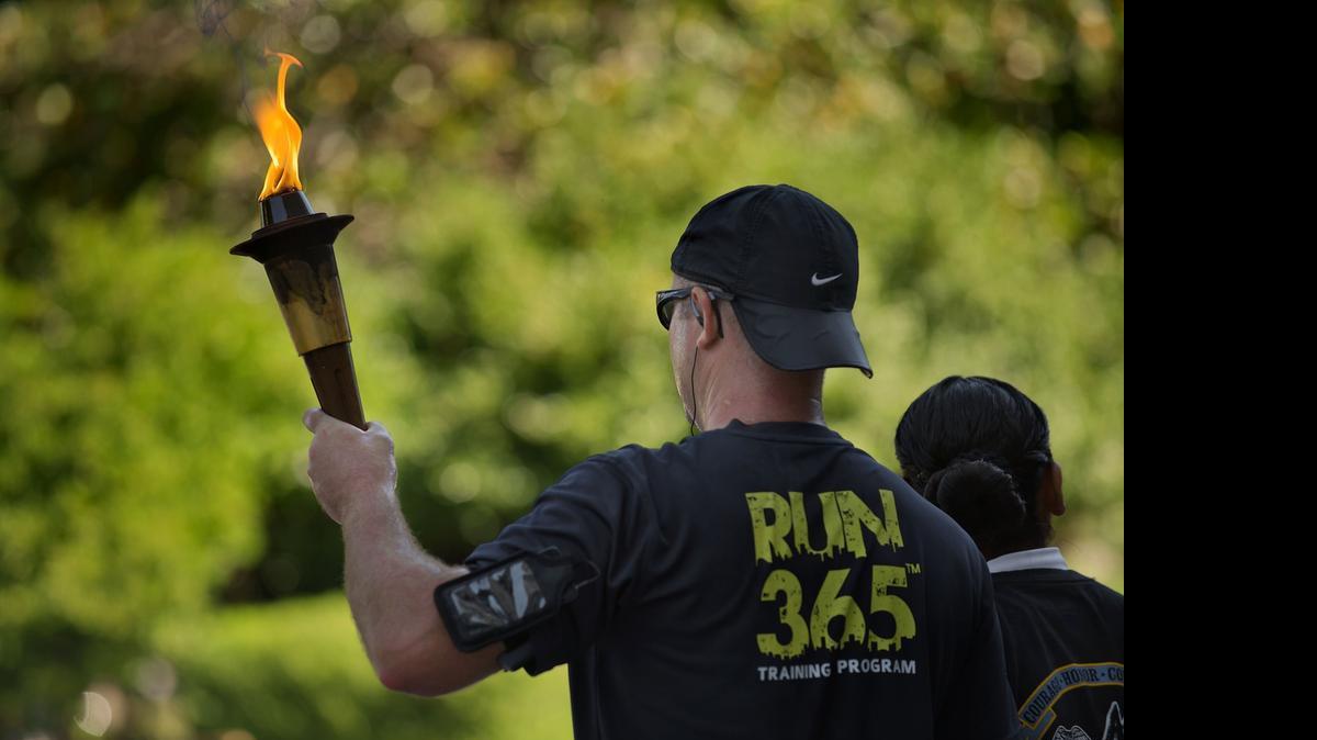 
In late June 2013, Kris Frey of the Citrus Heights Police Department carries the Flame of Hope as part of the Law Enforcement Torch Run on the west steps of the state Capitol in Sacramento.
