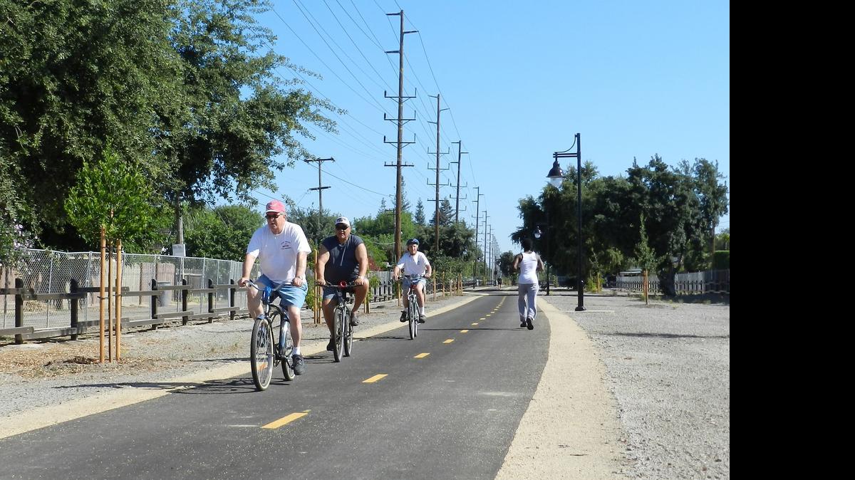 
Cyclists ride south from Woodrow Avenue on the new extension of the Virginia Corridor trail on Friday morning  in Modesto.
