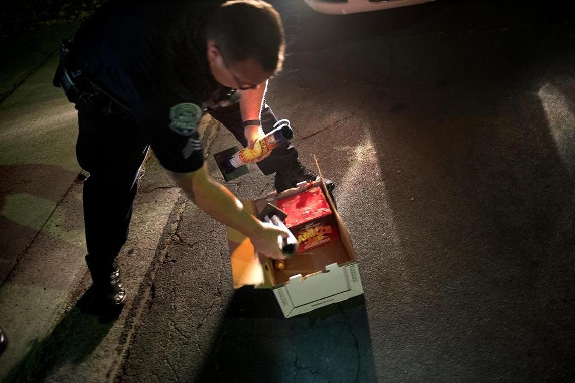 Modesto Police Sgt. Mike Hammond gathers illegal fireworks during an enforcement patrol in Modesto, Calif., on Tuesday, July 4, 2017.