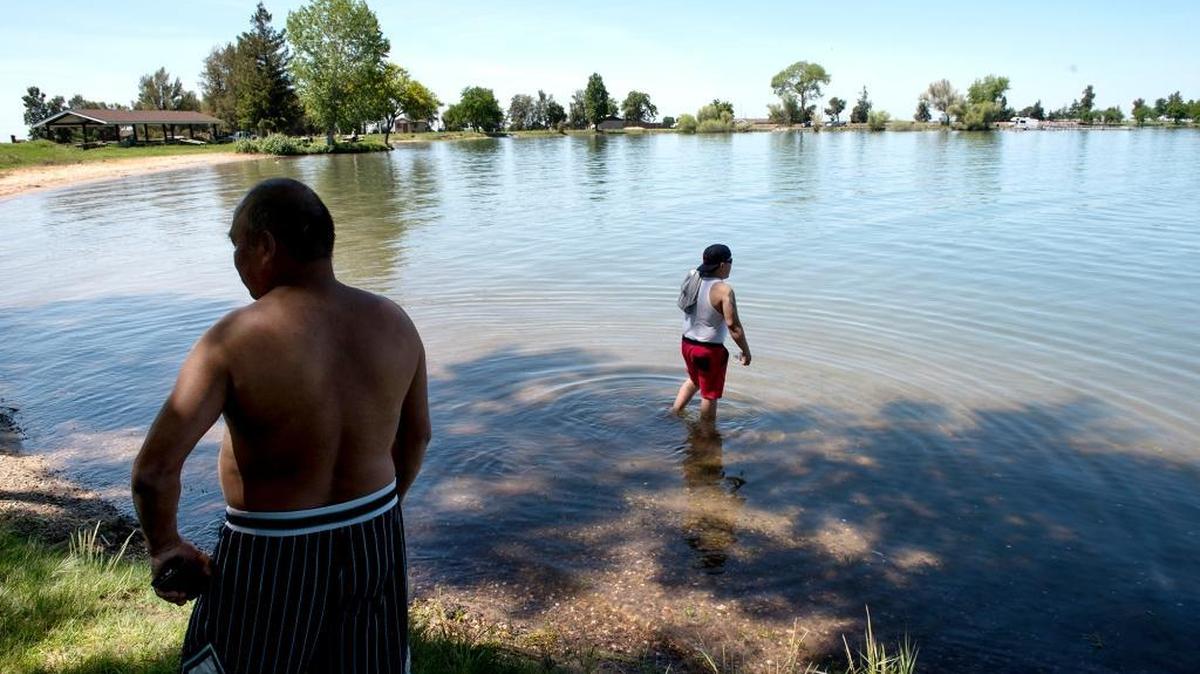 Javier Rodriguez, left, and Anthony Aquino-Delgado, both of Tracy, cool off at Woodward Reservoir in Oakdale on Monday, April, 18, 2016.