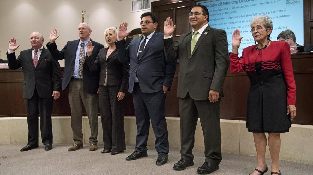 Modesto City Council members and Modesto City Schools board members take the oath of office in the basement chambers of Tenth Street Place on Tuesday, Nov. 28, 2017. From the left: Councilman Bill Zoslocki; school board members Chad Brown, Charlene West and Adolfo Lopez; and Councilman Tony Madrigal and Councilwoman Jenny Kenoyer.