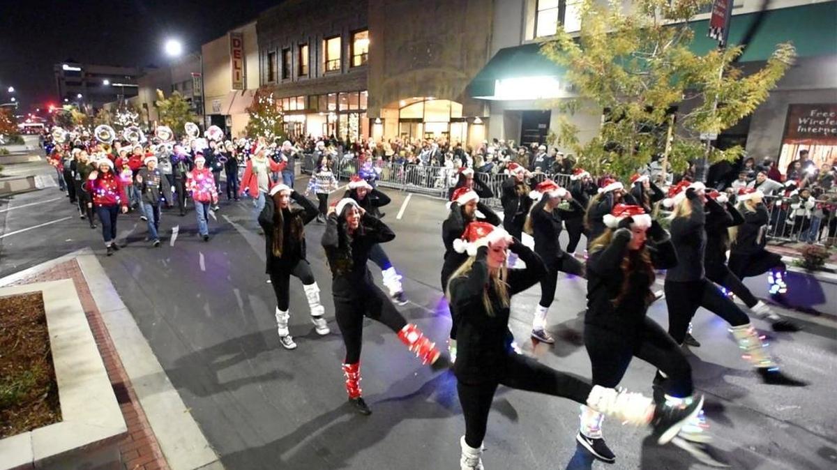 Members of the Enochs band and dancers perform on 10th Street during the Celebration of Lights Parade in Modesto on Saturday, Dec. 3, 2016.