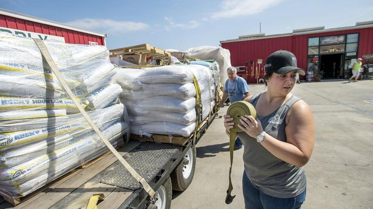 
Turlock Feed and Livestock owner Mary Lewellen prepares a truckload of donated supplies for those affected by the Butte fire on Tuesday.
