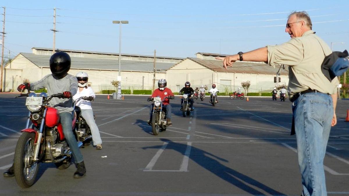 
Program director Jim Jenkins directs students at the California Motorcycle Safety Program class in a parking lot of the Modesto Junior College East Campus on Saturday, Aug.1, 2015.
