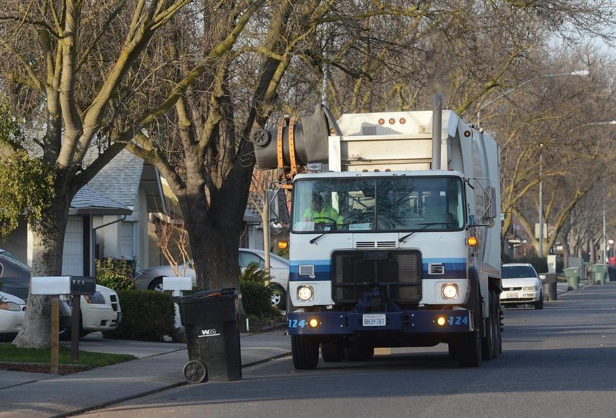 A Gilton Solid Waste Management garbage truck rolls down Dorset Lane near Pridmore Avenue in Modesto, California on Jan. 15, 2013.