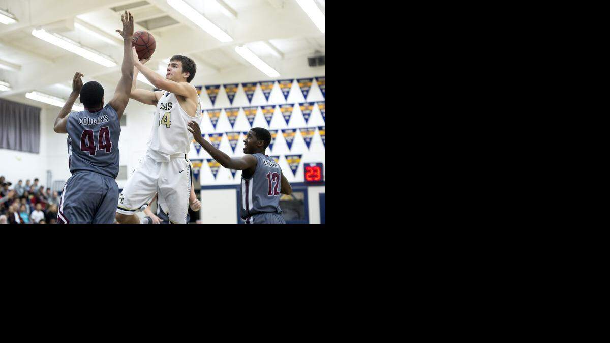 
Central Catholic forward Daniel Romeo shoots a jump shot over Weston Ranch defender Charles Udeze in the Valley Oak League game in Modesto on Tuesday, January, 6, 2015. Weston Ranch won the game 82-72.
