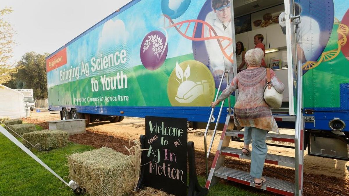 The Ag in Motion mobile trailer helps junior high schoolers get a taste of possible careers in agriculture. The laboratory is the best known project of the National Ag Science Center. Here, guests at a past fundraiser check out the trailer.