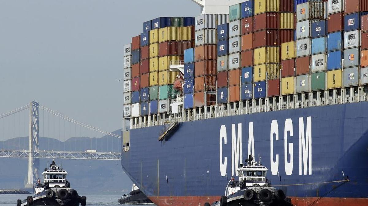 
A containership is guided by tugboats as it arrives at the Port of Oakland to be unloaded in February.
