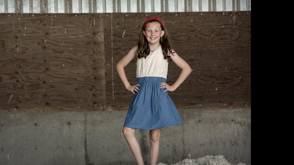 
Brielle Prock, 12, stands on a pile of cottonseed at the dairy where she lives in Hilmar, on Monday. Brielle is a California student ambassador for the Fuel up to Play 60 program promoting fitness and nutrition.

