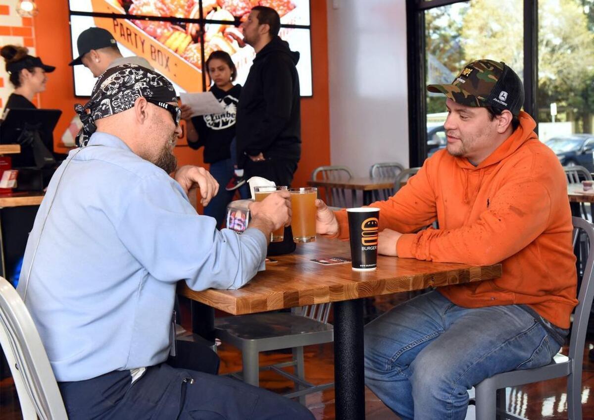 Michael Ballard and Troy Campos (right) enjoy themselves at BurgerIM on Carpenter road in Modesto, Calif.on Friday March 29, 2019. The burger franchise specializes in gourmet burgers with a wide range of toppings.