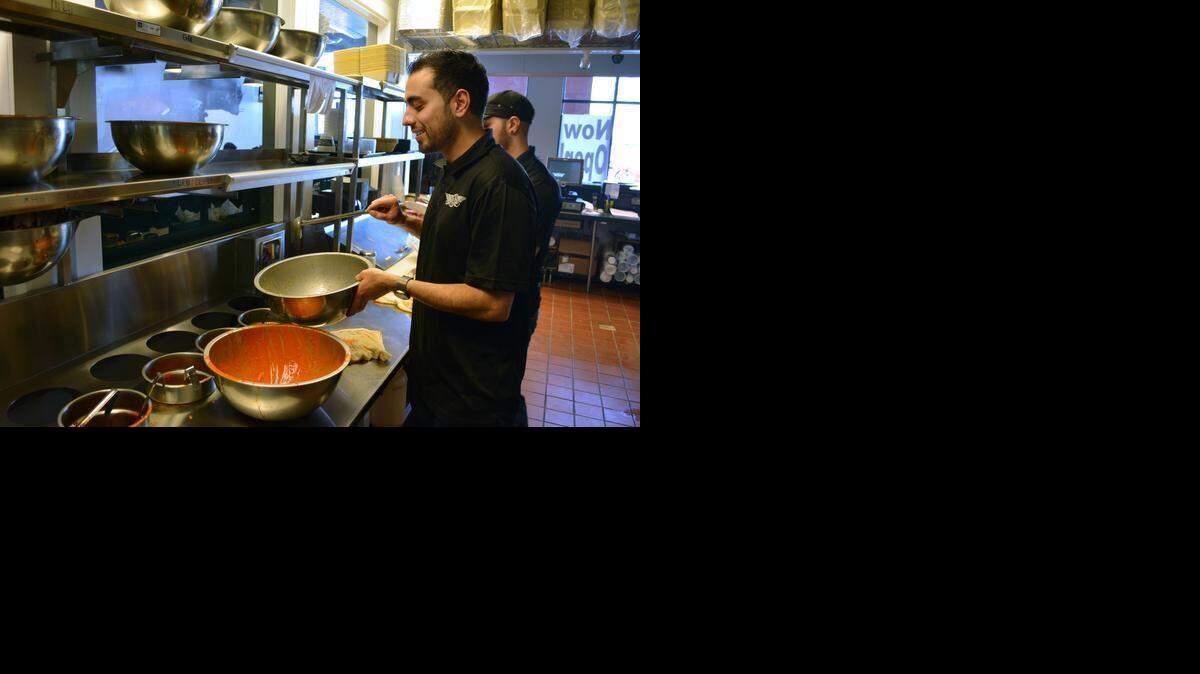 
Jason Khan makes lemon pepper wings at the new Wingstop in Ceres. Khan, who grew up in Modesto, now owns seven Wingstop restaurants.
