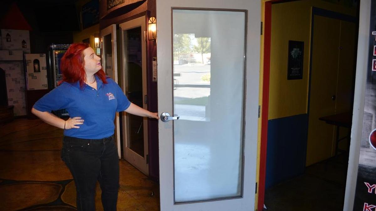 
Brianna Hammerstrom, assistant manager of Laser Quest, opens the door to the facility’s new escape room attraction.
