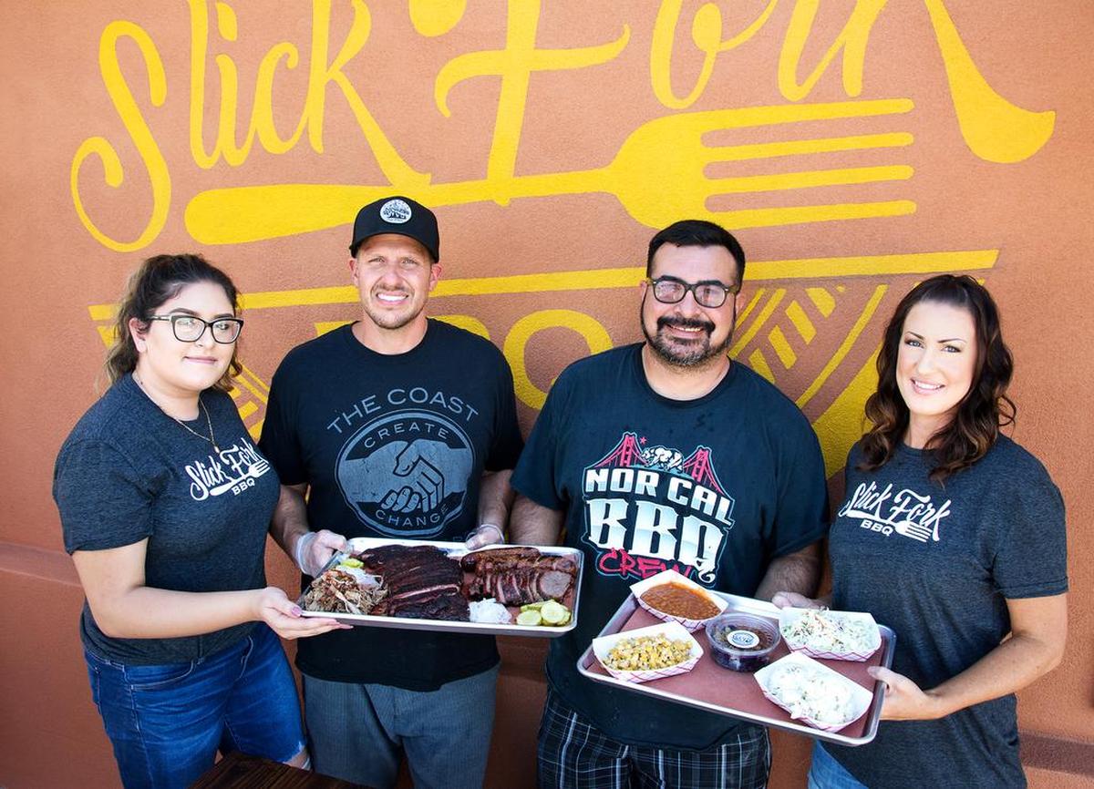 Slick Fork BBQ staff (left to right) Viveca Gudino, owner Kevin Bradley, partner Raul Gudino and employee Stacie Brasher show off plates of food at the restaurant in Hughson Friday, Sept. 21, 2018.