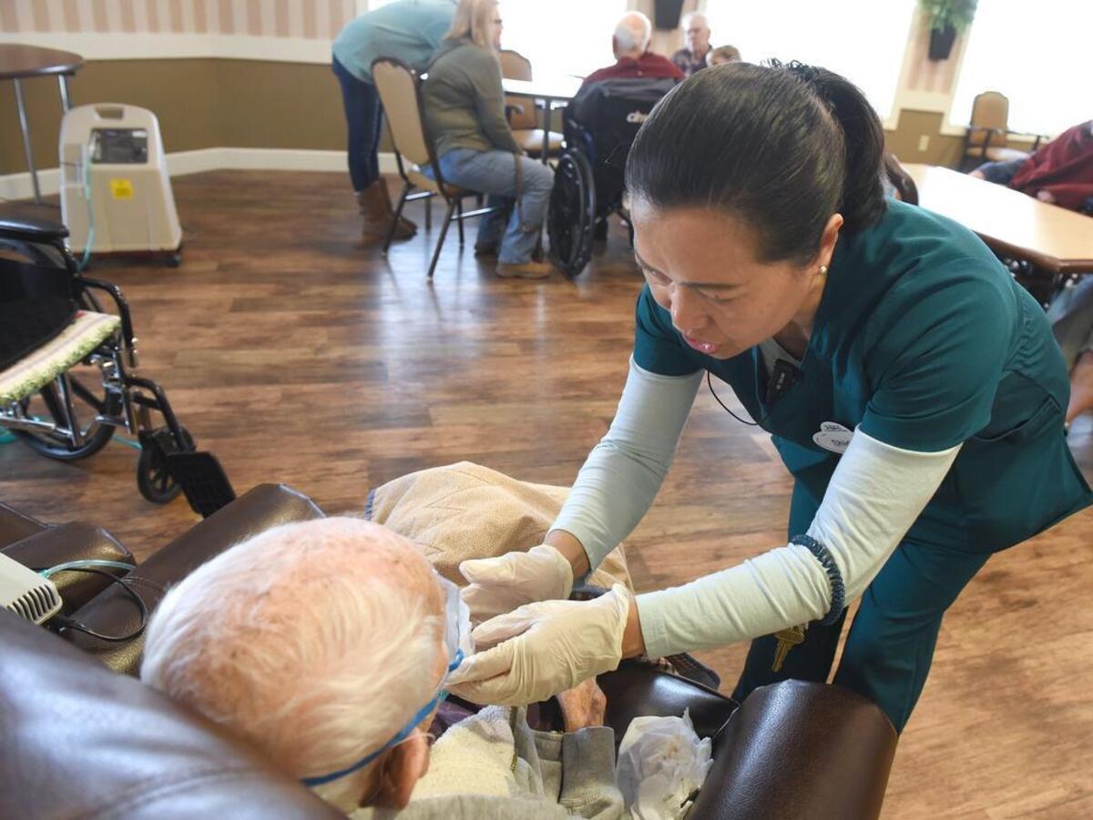 LVN Shirley Litang helps a resident with a breathing treatment at El Rio Memory Care in Modesto, Calif.on Thursday February 28, 2019.
