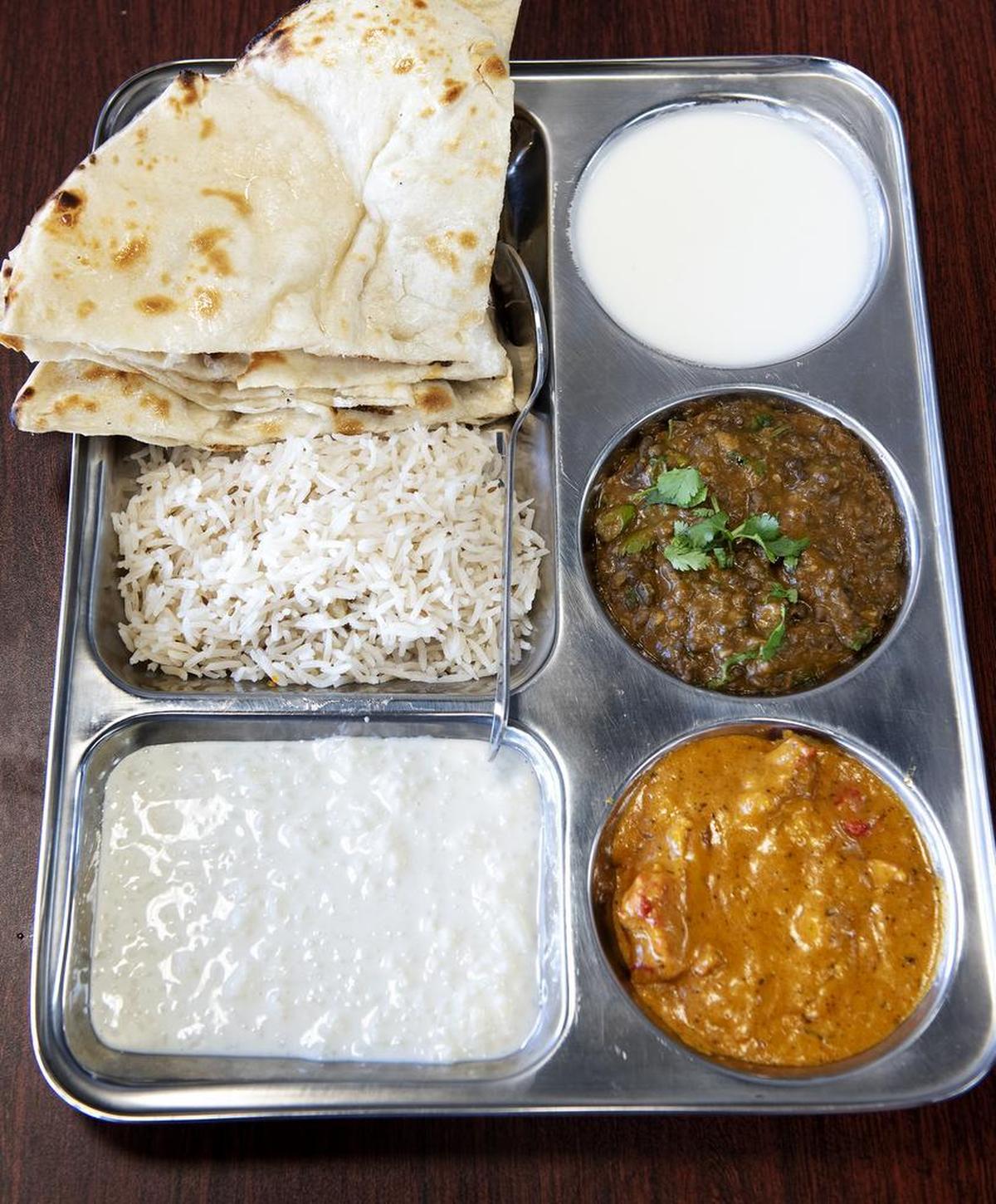 Lunch special: naan, rice pudding, butter chicken, and Dal Makhani (spiced creamy lentils) at Mother India Cuisine in Ceres, Calif., Saturday, Feb. 9, 2019.