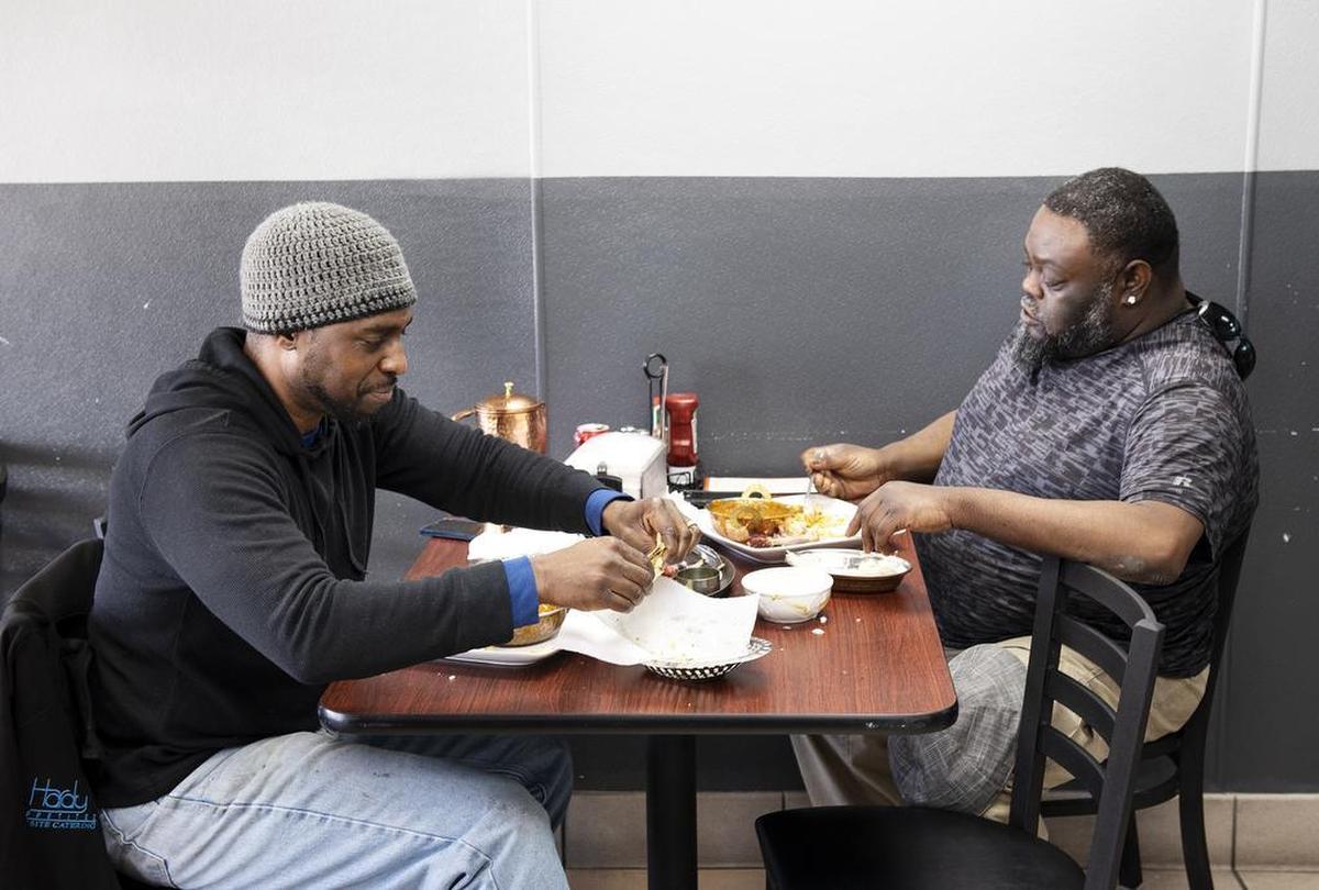 Corey Motley, right, and Knowledge Hardy, left, eat lunch at Mother India Cuisine in Ceres, Calif., Saturday, Feb. 9, 2019.