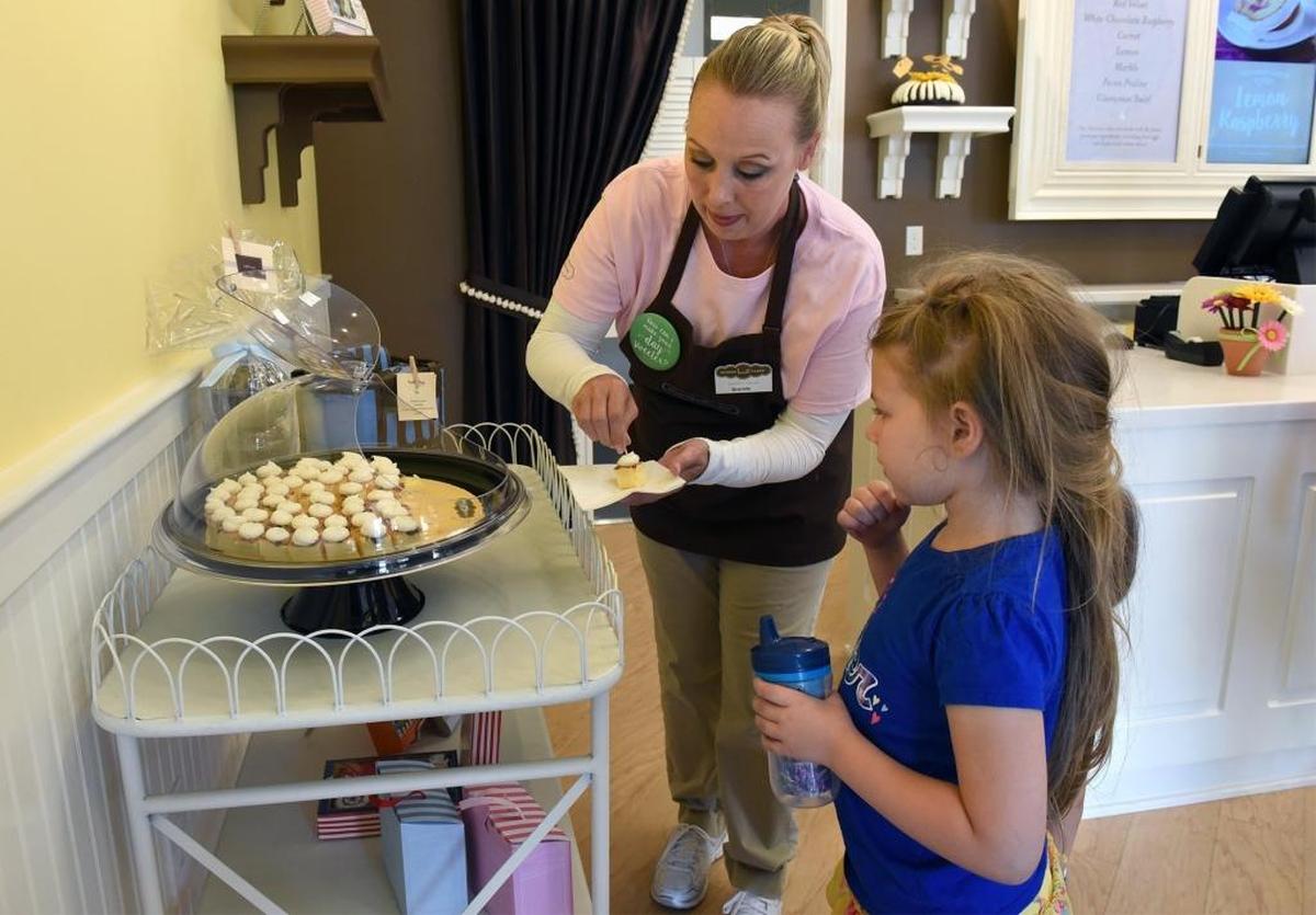 Brandy Hawkins gives a sample to Emily Taylor, 5, at Nothing Bundt Cakes on Thursday morning, Aug. 18, 2016, in Modesto, Calif.